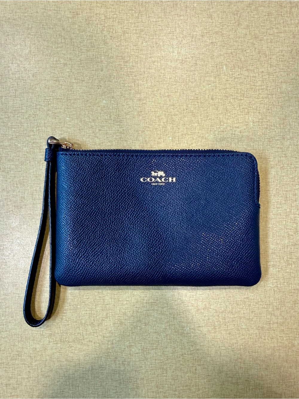 COACH Navy Pebbled Leather Wristlet with Gold Logo